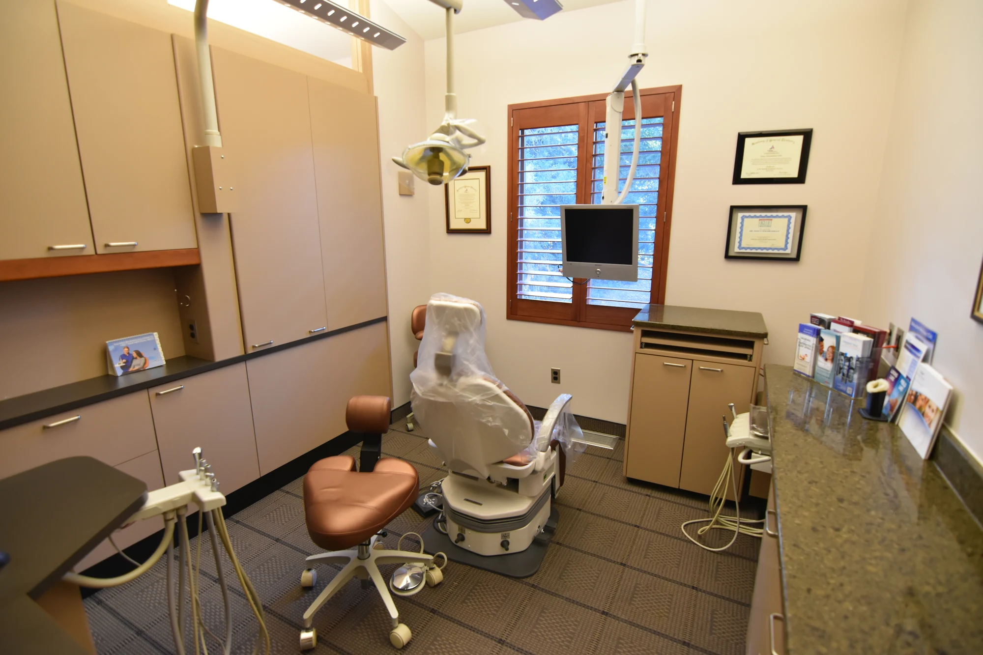 Dental chair, equipment, and cabinets in a Top Down Dental treatment room