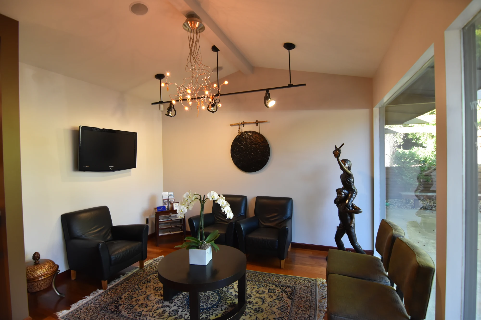 Waiting room seating and artwork at Top Down Dental