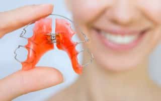 woman holding a retainer