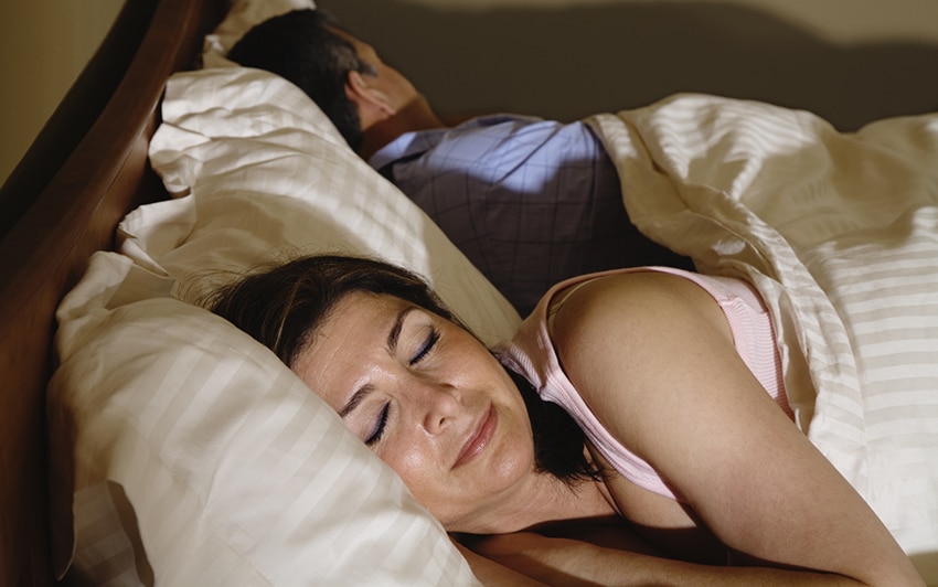 Middle-aged couple sleeping in bed