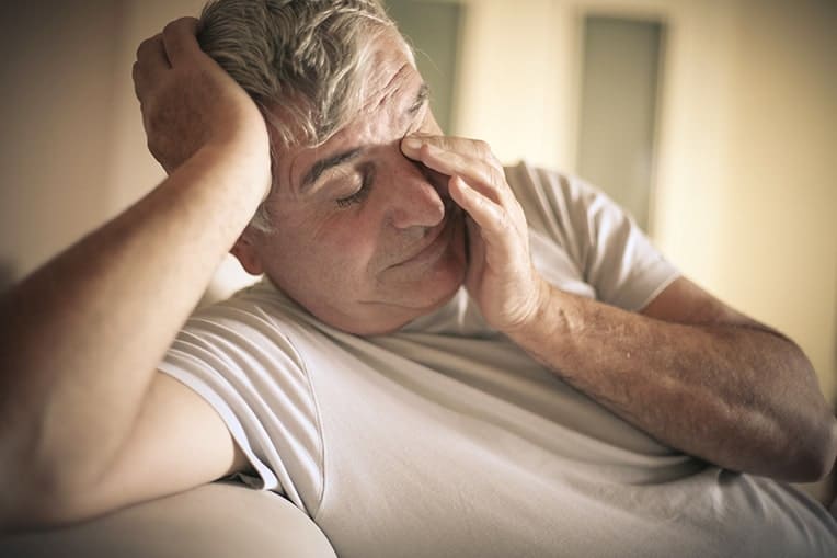 Aged man rubbing eyes and head. Is your Sleep Apnea aging you?