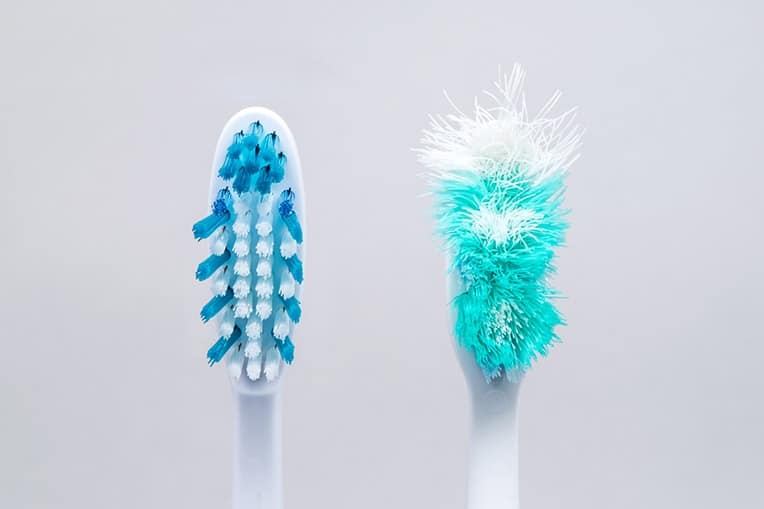 Two toothbrushes next to each other, one new and another very used. Researchers at Queen’s University Belfast conducted a study that suggests a link between poor oral health and an increased risk of liver cancer, yet another study that suggests your oral health impacts your health beyond just your mouth.