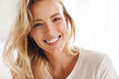 young woman smiling with teeth