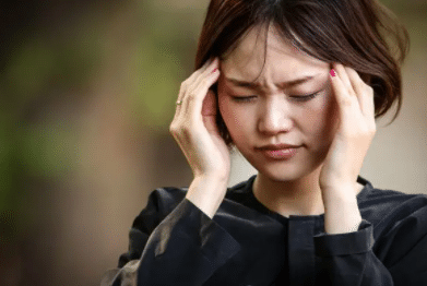 young woman suffering from migraine