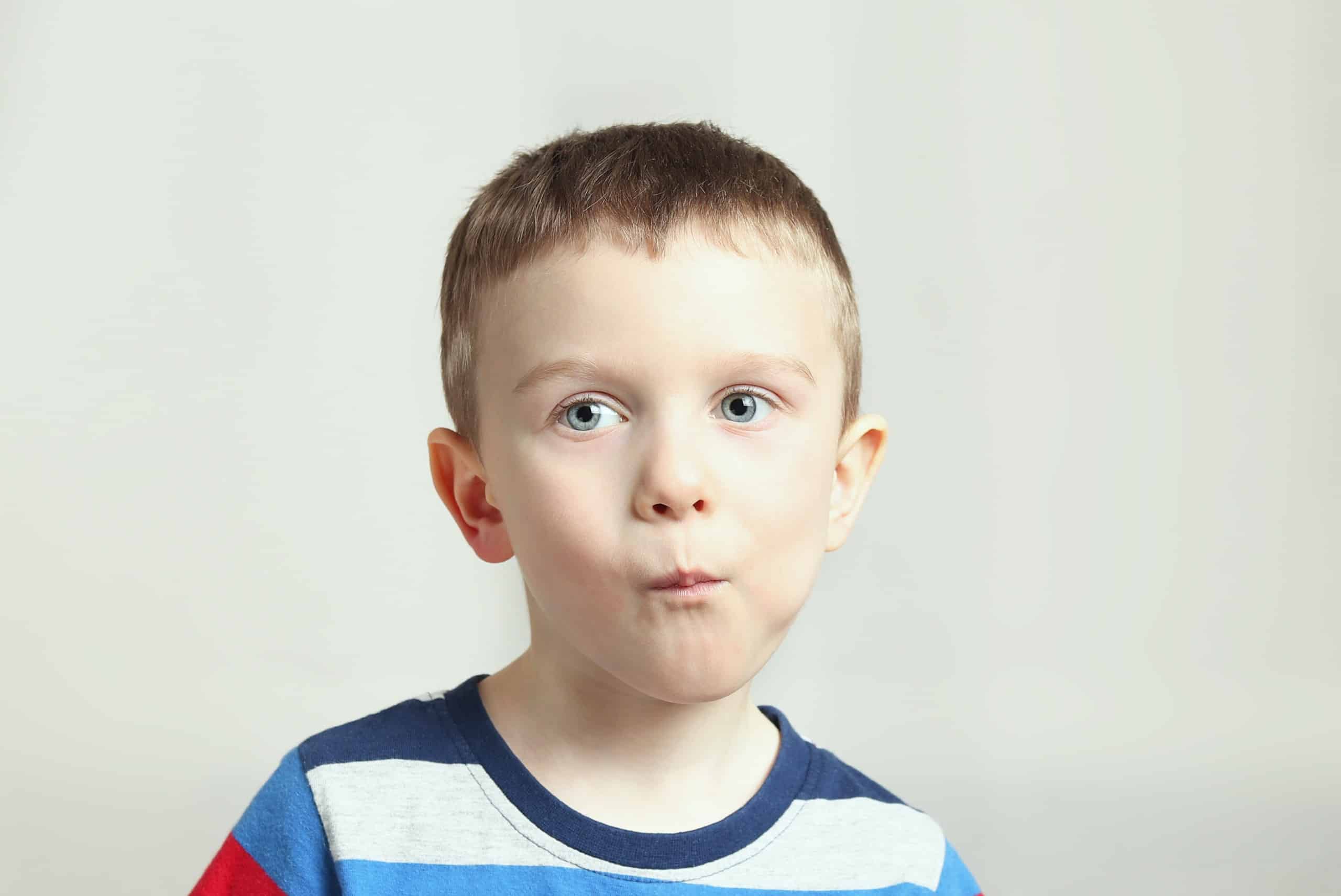 Boy, kid performs articulation exercises for the tongue, correct pronunciation, vocals, dental concept, speech therapy Boy perform articulation tongue exercises